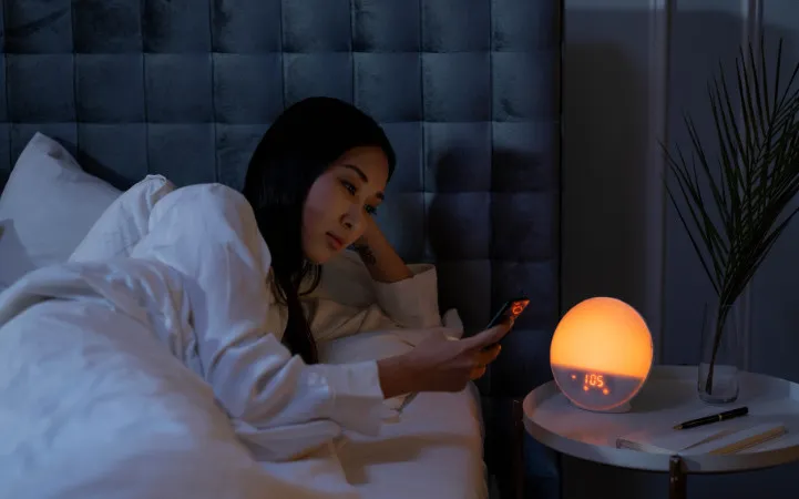 Person resting with headphones in dim light